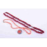 Two coral necklaces, one dark coral, length approx 21" and one light coral, length approx. 14" and a