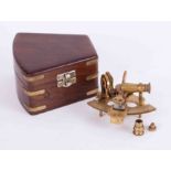 A reproduction miniature sextant in hardwood and brass bound military type box, length 13cm x 14cm.