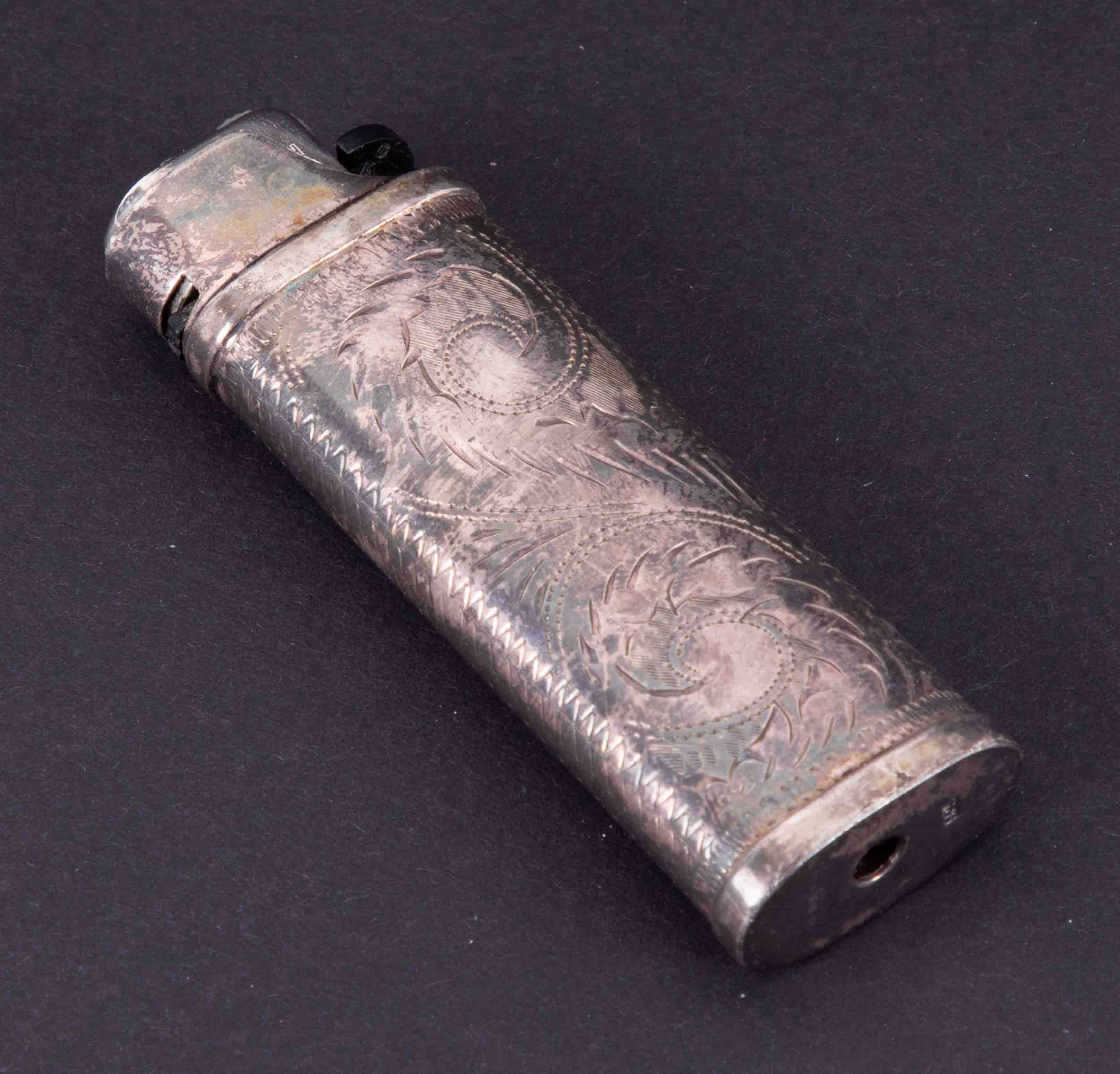 A silver cased lighter with scrolling leaf detail (40gms) together with a George V silver compact (