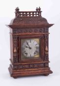 A Victorian carved oak mantle clock, the dial indistinctly marked "Adams" with eight day movement