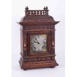 A Victorian carved oak mantle clock, the dial indistinctly marked "Adams" with eight day movement