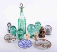 A mixed collection of coloured glass including paperweights, also some Oriental carvings and