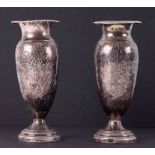 A pair of silver bud vases with hammered effect.