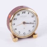 A Looping fifteen jewel travel alarm clock with enamelled decoration and leather case.