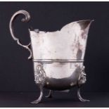 Newcastle silver cream jug on three feet with sterilised face decoration, height 12.5cm, 250gms.