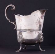 Newcastle silver cream jug on three feet with sterilised face decoration, height 12.5cm, 250gms.