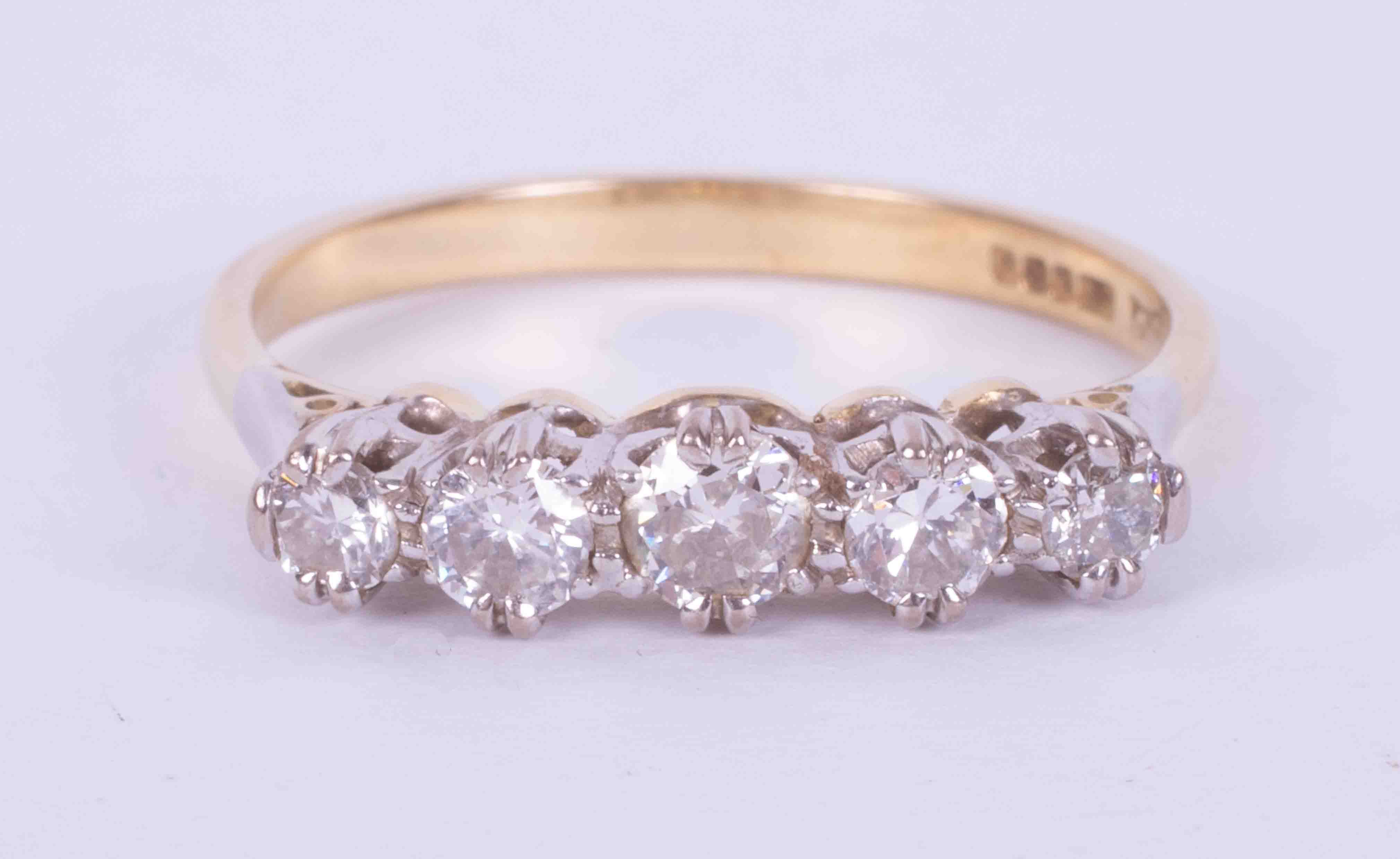An 18ct yellow & white gold five stone ring set with approx. 0.79 carats of round brilliant cut