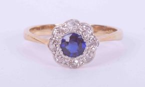 An 18ct yellow & white gold flower cluster ring set with approx. 0.36 carats of round cut sapphire