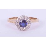 An 18ct yellow & white gold flower cluster ring set with approx. 0.36 carats of round cut sapphire