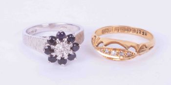 Two 18ct gold rings to include an 18ct white gold flower cluster style ring set sapphires & a