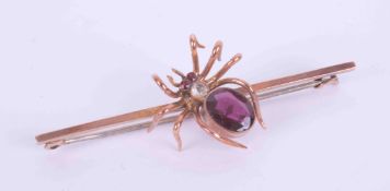 A 9ct rose gold Victorian spider brooch, the spider is set with an oval cut almandine garnet,