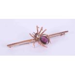 A 9ct rose gold Victorian spider brooch, the spider is set with an oval cut almandine garnet,