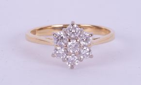 An 18ct yellow & white gold flower cluster ring set with approx.0.45 carats total weight of round