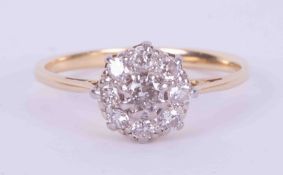 An 18ct yellow & white gold (not hallmarked or tested) flower cluster ring set with old round cut