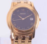 Gucci, a gold plated date wristwatch with black dial, boxed.