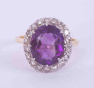 An 18ct yellow gold & platinum cluster ring set with an oval cut amethyst approx. 4.45 carats,