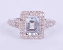 An 18ct white gold ring set with 0.95 carats of emerald cut Aquamarine, surrounded by 0.65 carats