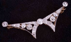 A yellow & white gold (not hallmarked or tested) stylized butterfly brooch with yellow pin &