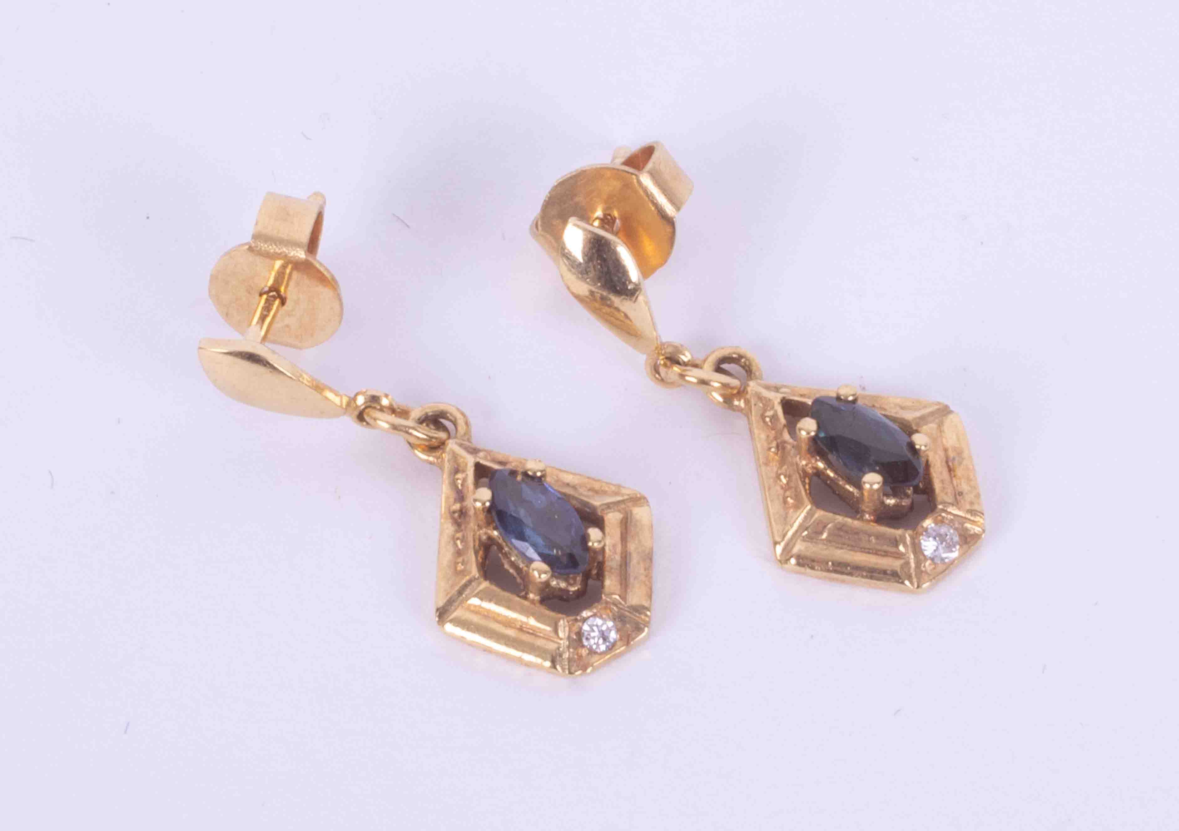 A pair of 9ct yellow gold drop earrings set with a lozenge shaped sapphire and a small round cut