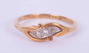 An 18ct yellow & white gold twist style ring set with three small old round cut diamonds, 2.51gm,