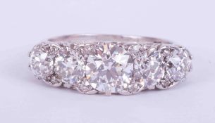 An impressive antique 18ct white gold five stone ring set with old round cut diamonds, total diamond