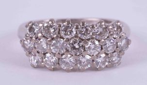 An 18ct white gold three row ring set with nineteen round brilliant cut diamonds, approx. total