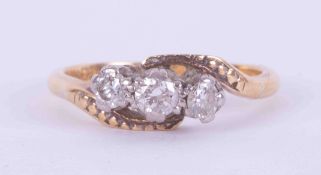 An 18ct yellow & white gold three stone twist ring set with approx. 0.25 carats total weight of