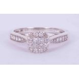 A 9ct white gold cluster style ring set with 0.33 carats total weight of round & princess cut