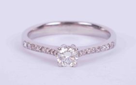 An 18ct white gold ring set with a central round brilliant cut diamond, approx. 0.26 carats,