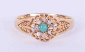 An 18ct yellow gold antique ring set with a cabochon cut turquoise and surrounded by small old rough