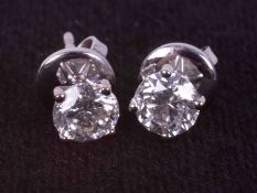 A pair of 18ct white gold studs set with a total weight of approx. 1.20 carats of round brilliant