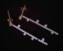 A pair of 9ct yellow & white gold bar drop earrings set with round brilliant cut diamonds, total