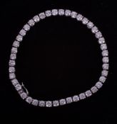 A fine 18ct white gold line bracelet set with 9.00 carats total weight of round brilliant cut