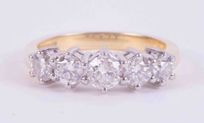 An 18ct yellow & white gold ring set with five round brilliant cut diamonds, total weight 1.00