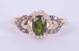 A 14k yellow gold Le Vian ring set with a central oval cut chrome diopside, approx. 0.75 carats,