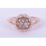 A 14k rose gold split shoulder ring by Le Vian with round brilliant cut chocolate diamonds set