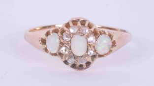 An antique yellow gold (not hallmarked or tested) ring set with three oval cabochon cut white opals,