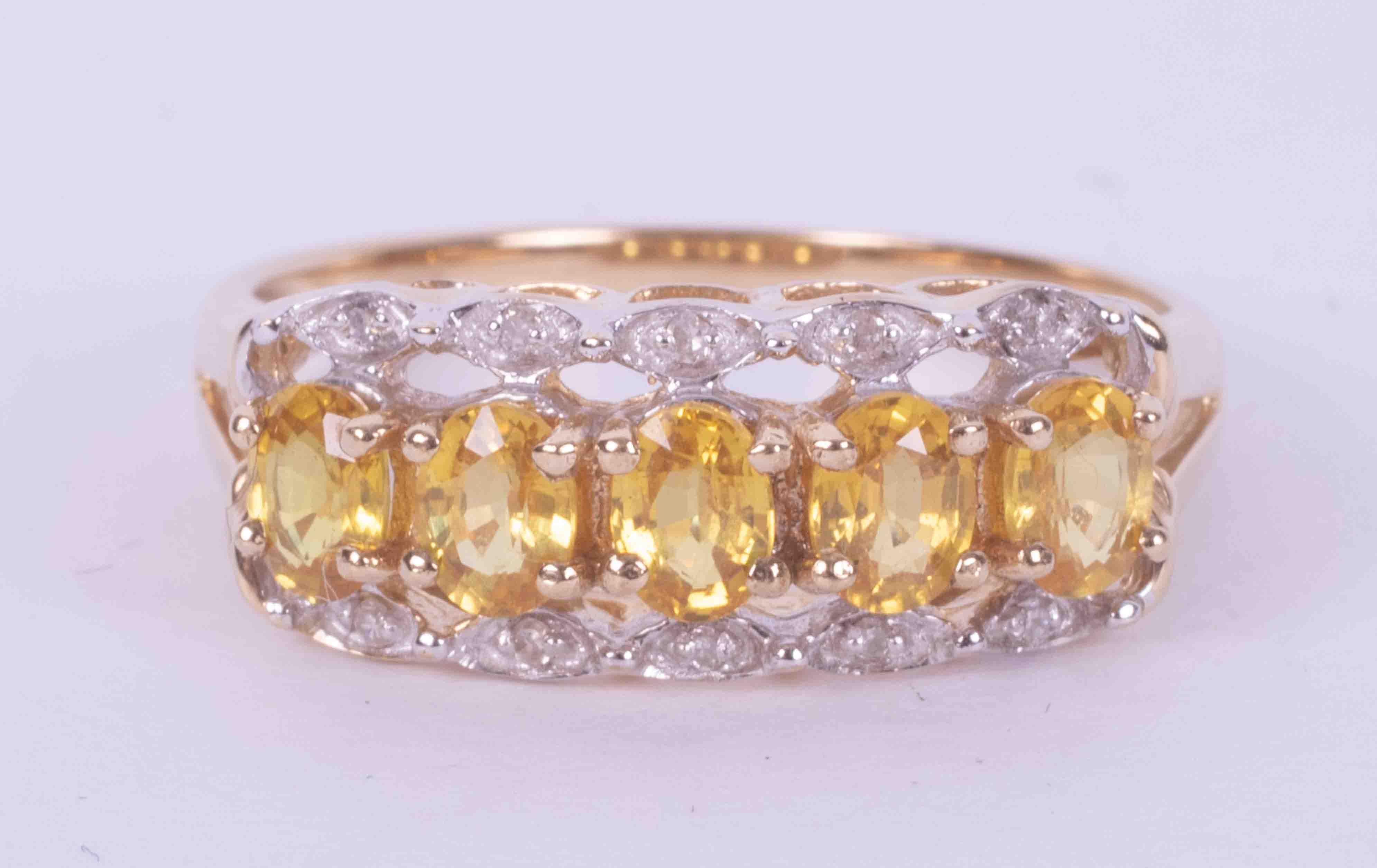 A 9ct yellow and white gold ring set with five oval cut yellow sapphires, approx. total weight 0.