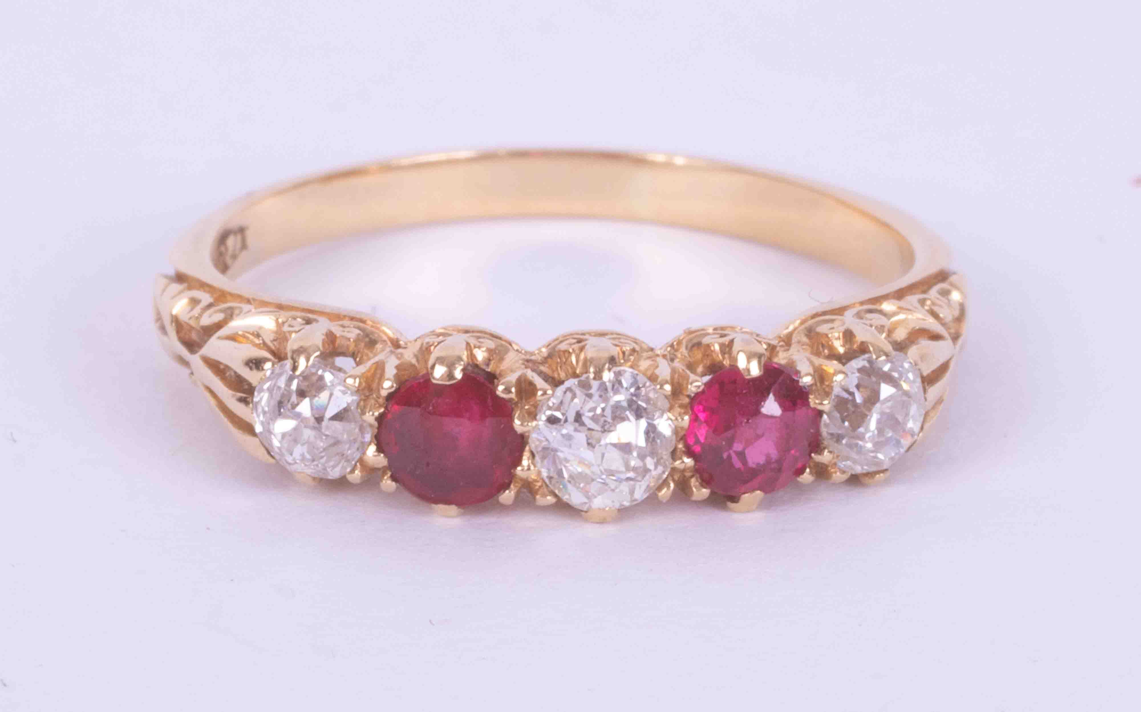 An 18ct yellow gold five stone gypsy style ring set with three old round cut diamonds, total