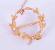 A high carat gold (not tested or hallmarked) Victorian wreath brooch set with eight seed pearls