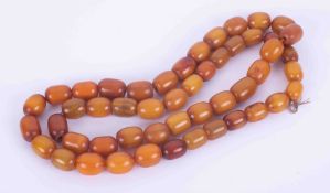 A string of various sized amber beads, approx. 144.1gm, not knotted, approx. 35" in length.