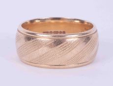 A 9ct yellow gold engraved wedding band, approx. 10mm wide, 11.84gm, size U.