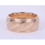 A 9ct yellow gold engraved wedding band, approx. 10mm wide, 11.84gm, size U.