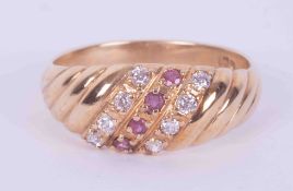 A 9ct yellow gold ring set with four small round cut rubies and eight small round brilliant cut