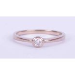 An 18ct white gold ring set with approx. 0.15 carats of round brilliant cut diamond in a rub-over