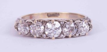 An 18ct yellow gold five stone ring set with approx. 1.20 carats of old round cut diamonds,