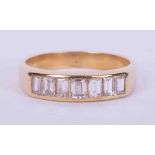 An 18ct yellow gold half eternity style ring set with seven baguette cut diamonds, approx. 0.70