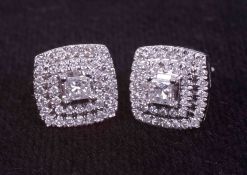 A pair of 9ct white gold square cluster stud earrings set with a central princess cut diamond