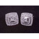 A pair of 9ct white gold square cluster stud earrings set with a central princess cut diamond