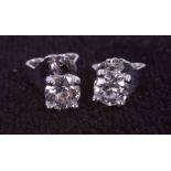 A pair of 18ct white gold four claw stud earrings set with 0.40 carats of round brilliant cut